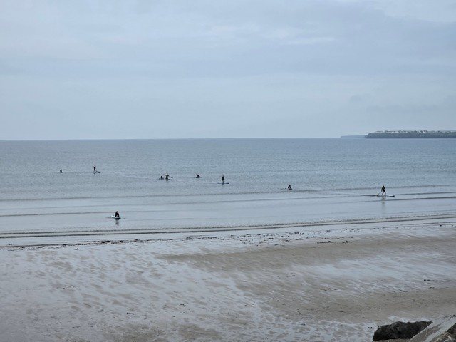 a few people in the water but no waves